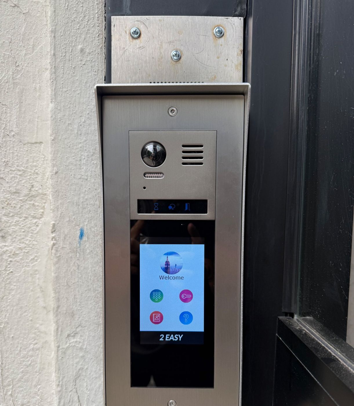 Touchscreen video intercom panel installed at a building entrance